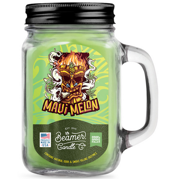 Clear glass candle jar with black lid and Maui Melon label featuring a tiki design.