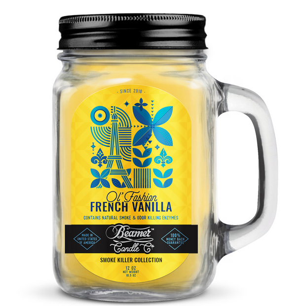 Jar candle with a yellow label featuring the Eiffel Tower and text, on a white background.