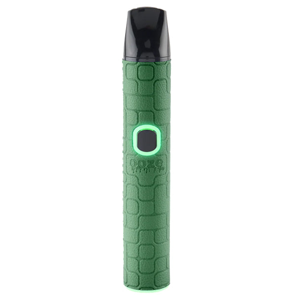 A green Oooze Pinch Dry Herb device with a textured light blue body, a black mouthpiece, and a glowing green button, shown on a solid white background.