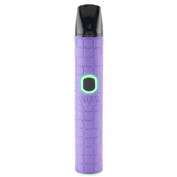 A lilac Oooze Pinch Dry Herb device with a textured light blue body, a black mouthpiece, and a glowing green button, shown on a solid white background.