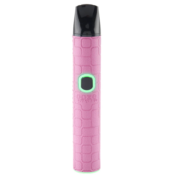 A pink Oooze Pinch Dry Herb device with a textured light blue body, a black mouthpiece, and a glowing green button, shown on a solid white background.