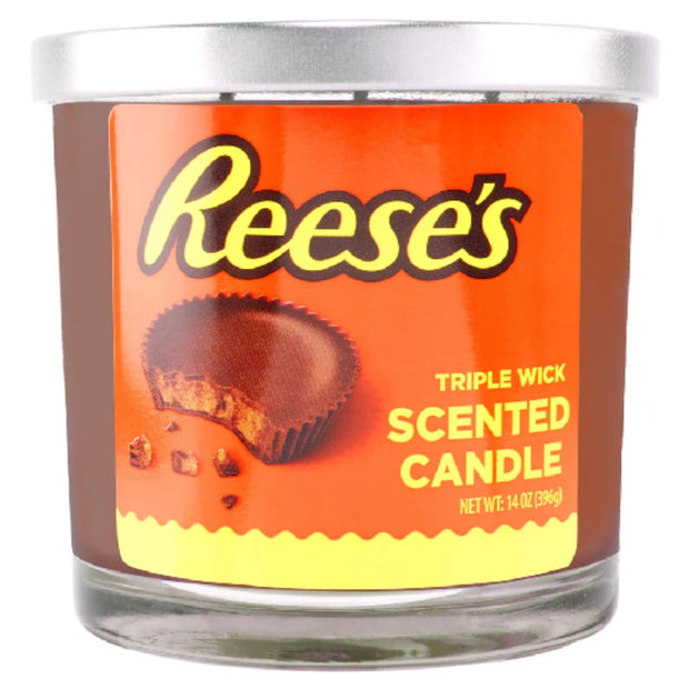 Reese's scented candle with orange label and silver lid on a white background