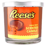 Reese's scented candle with orange label and silver lid on a white background