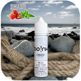 Boink Smash Strawberry Spearmint e-liquid bottle on a beach with ocean and rocks in the background