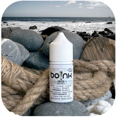 boInk Smash e-liquid bottle on a rocky beach with ocean view