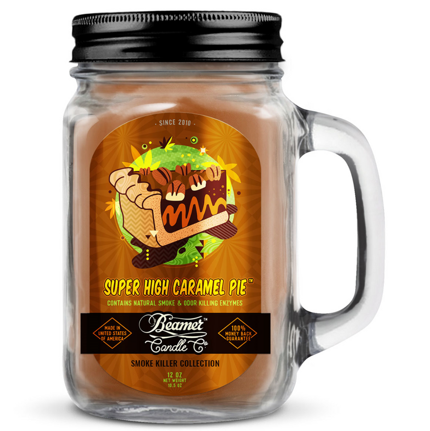 Jar candle labeled 'Super High Caramel Pie' with a black lid and handle on a white background