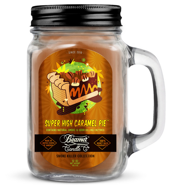 Jar candle labeled 'Super High Caramel Pie' with a black lid and handle on a white background