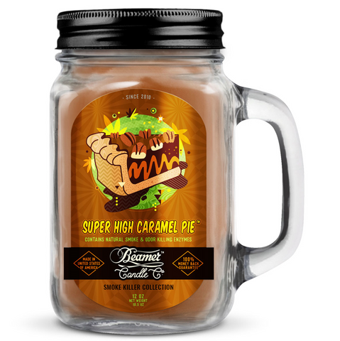 Jar candle labeled 'Super High Caramel Pie' with a black lid and handle on a white background