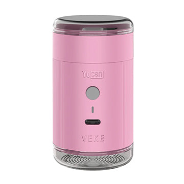 A pink Yocan Yeke Electric Grinder with a clear top and bottom, featuring the Yocan and VEKE logos on the front, set against a plain white background.
