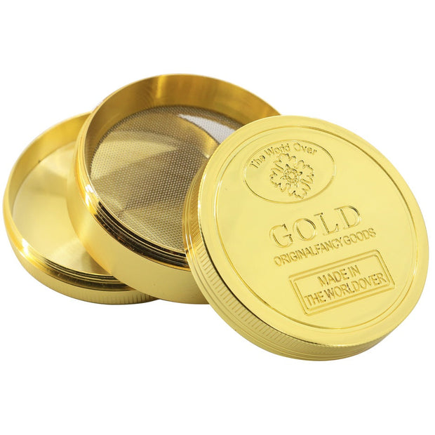 Gold dry herb grinder on white background.